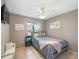 Cozy bedroom with neutral walls, tile floors, a ceiling fan and natural lighting at 2720 Wiltshire Ave, Palm Harbor, FL 34685