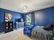 Inviting bedroom with tile floor and bright blue walls, providing a peaceful retreat at 2720 Wiltshire Ave, Palm Harbor, FL 34685