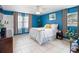 Bright bedroom boasts tile floors, blue walls, and lots of natural light from the window at 2720 Wiltshire Ave, Palm Harbor, FL 34685