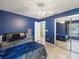 Comfortable bedroom with blue walls, mirrored closet, and natural lighting at 2720 Wiltshire Ave, Palm Harbor, FL 34685