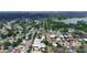 Aerial view of a residential neighborhood with mature trees, a nearby lake, and well-maintained streets at 2805 W Patterson St, Tampa, FL 33614