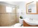 Bathroom with a glass enclosed shower, tiled floors and a wood vanity at 2805 W Patterson St, Tampa, FL 33614