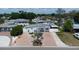 Exterior aerial view of a well-kept home with a fountain, brick driveway, and mature landscaping at 2805 W Patterson St, Tampa, FL 33614