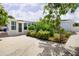 Well-maintained exterior with mature landscaping, a sunroom addition, and a spacious driveway at 2805 W Patterson St, Tampa, FL 33614