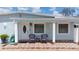 Charming front porch with tile flooring and seating area, and white pillars at 2805 W Patterson St, Tampa, FL 33614