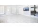 Sunroom boasts bright tile flooring, access to the outdoors, and a wall-mounted television at 2805 W Patterson St, Tampa, FL 33614