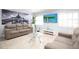 Cozy living room featuring comfortable seating, a wall-mounted TV, and a view of the lush outdoor scenery at 2805 W Patterson St, Tampa, FL 33614