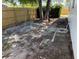 View of the backyard, bordered by a new wooden fence and featuring mature trees at 29813 69Th N St, Clearwater, FL 33761