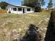 Large backyard of a white home featuring a wood fence at 29813 69Th N St, Clearwater, FL 33761