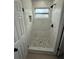 Bathroom shower with white and gray marble-patterned walls and stone floor at 29813 69Th N St, Clearwater, FL 33761