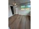 This bedroom features wood flooring, a ceiling fan, and natural light from the window at 29813 69Th N St, Clearwater, FL 33761