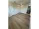 Bright bedroom with light wood floors, ceiling fan, closet, and ample natural light at 29813 69Th N St, Clearwater, FL 33761