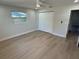 A bright bedroom featuring new floors, a modern ceiling fan, and double door closet, perfect for storage at 29813 69Th N St, Clearwater, FL 33761