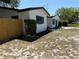Charming single-story home featuring fresh exterior paint, dark shutters and a manicured garden bed at 29813 69Th N St, Clearwater, FL 33761