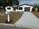 Charming home featuring a black garage door and a white mailbox at 29813 69Th N St, Clearwater, FL 33761