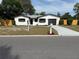 Charming home featuring a black garage door and a white mailbox at 29813 69Th N St, Clearwater, FL 33761