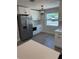 Modern kitchen featuring sleek stainless steel appliances, white cabinets, and subway tile backsplash at 29813 69Th N St, Clearwater, FL 33761