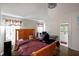 Bedroom with wood floors, desk, and an attached bathroom with modern fixtures at 302 Summer Sails Dr, Valrico, FL 33594