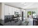 Modern kitchen with white cabinets, stainless steel appliances, a dark countertop, and a mosaic backsplash at 302 Summer Sails Dr, Valrico, FL 33594