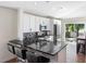 Modern kitchen featuring white cabinetry, a breakfast bar, and stainless steel appliances at 302 Summer Sails Dr, Valrico, FL 33594