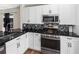 Contemporary kitchen with sleek stainless steel appliances, modern cabinets, and elegant countertops at 302 Summer Sails Dr, Valrico, FL 33594