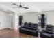 The living room features wood floors, a ceiling fan, and a comfortable reclining sofa at 302 Summer Sails Dr, Valrico, FL 33594
