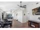 Spacious living room featuring tile floors, ceiling fans, and an open view into the kitchen at 302 Summer Sails Dr, Valrico, FL 33594