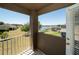 Outdoor balcony featuring a view of a serene lake and community with lush landscaping at 30526 Annadale Dr, Wesley Chapel, FL 33545