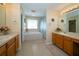 Bright bathroom featuring double vanity, soaking tub, and separate shower at 30526 Annadale Dr, Wesley Chapel, FL 33545