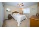 Spacious bedroom with neutral walls, ceiling fan, and coordinated furnishings at 30526 Annadale Dr, Wesley Chapel, FL 33545