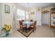Charming breakfast nook featuring a round table, four chairs, and abundant natural light from the surrounding windows at 30526 Annadale Dr, Wesley Chapel, FL 33545