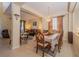 The dining room features chandelier lighting, natural light and is open to the living room at 30526 Annadale Dr, Wesley Chapel, FL 33545
