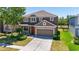 Charming two-story home with a well-maintained lawn, inviting front porch and a two car garage at 30526 Annadale Dr, Wesley Chapel, FL 33545