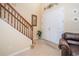 Inviting Foyer featuring tile floors, staircase with wood banister and double door entry at 30526 Annadale Dr, Wesley Chapel, FL 33545