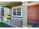 Welcoming front porch with flowers and comfortable seating at 30526 Annadale Dr, Wesley Chapel, FL 33545