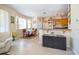 The kitchen features an island, granite countertops and wood cabinets, conveniently positioned near a breakfast nook at 30526 Annadale Dr, Wesley Chapel, FL 33545