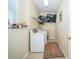 Functional laundry room equipped with a washing machine, dryer, shelving, and a window for natural light at 30526 Annadale Dr, Wesley Chapel, FL 33545