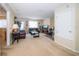 Spacious living room featuring a plush sofa, a television, a door to the outdoors, and neutral-toned walls at 30526 Annadale Dr, Wesley Chapel, FL 33545