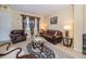 This cozy living room is complete with tile floors, leather furniture and natural light at 30526 Annadale Dr, Wesley Chapel, FL 33545