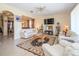 Spacious living room featuring tile floors and an open concept design with a view of the dining room at 30526 Annadale Dr, Wesley Chapel, FL 33545