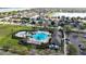 Stunning aerial view of the community pool and clubhouse amidst lush landscaping and palm trees at 30526 Annadale Dr, Wesley Chapel, FL 33545