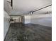 Spacious garage with concrete flooring, offering ample space for parking and storage at 3109 Chessington Dr, Land O Lakes, FL 34638