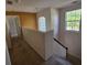 Upstairs hallway with carpet flooring, window, and staircase access at 3109 Chessington Dr, Land O Lakes, FL 34638
