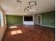 Bright living room showcasing hardwood floors, recessed lighting, and a seamless flow to the kitchen at 3109 Chessington Dr, Land O Lakes, FL 34638