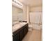 Bright bathroom featuring a double sink vanity and a shower-tub combination at 32699 Dashel Palm Ln, Wesley Chapel, FL 33543