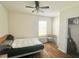 Well-lit bedroom featuring wood floors, ceiling fan, and a closet at 32699 Dashel Palm Ln, Wesley Chapel, FL 33543