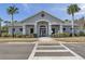 Exterior view of the community clubhouse featuring a welcoming entrance and landscaping at 32699 Dashel Palm Ln, Wesley Chapel, FL 33543