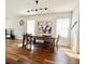 Dining room with a large table, wood floors, and bright windows at 32699 Dashel Palm Ln, Wesley Chapel, FL 33543