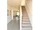 Inviting entryway with staircase and view of living area, creating a warm welcome at 32699 Dashel Palm Ln, Wesley Chapel, FL 33543