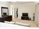 Bedroom with dresser, TV and view of an ensuite entrance at 32699 Dashel Palm Ln, Wesley Chapel, FL 33543